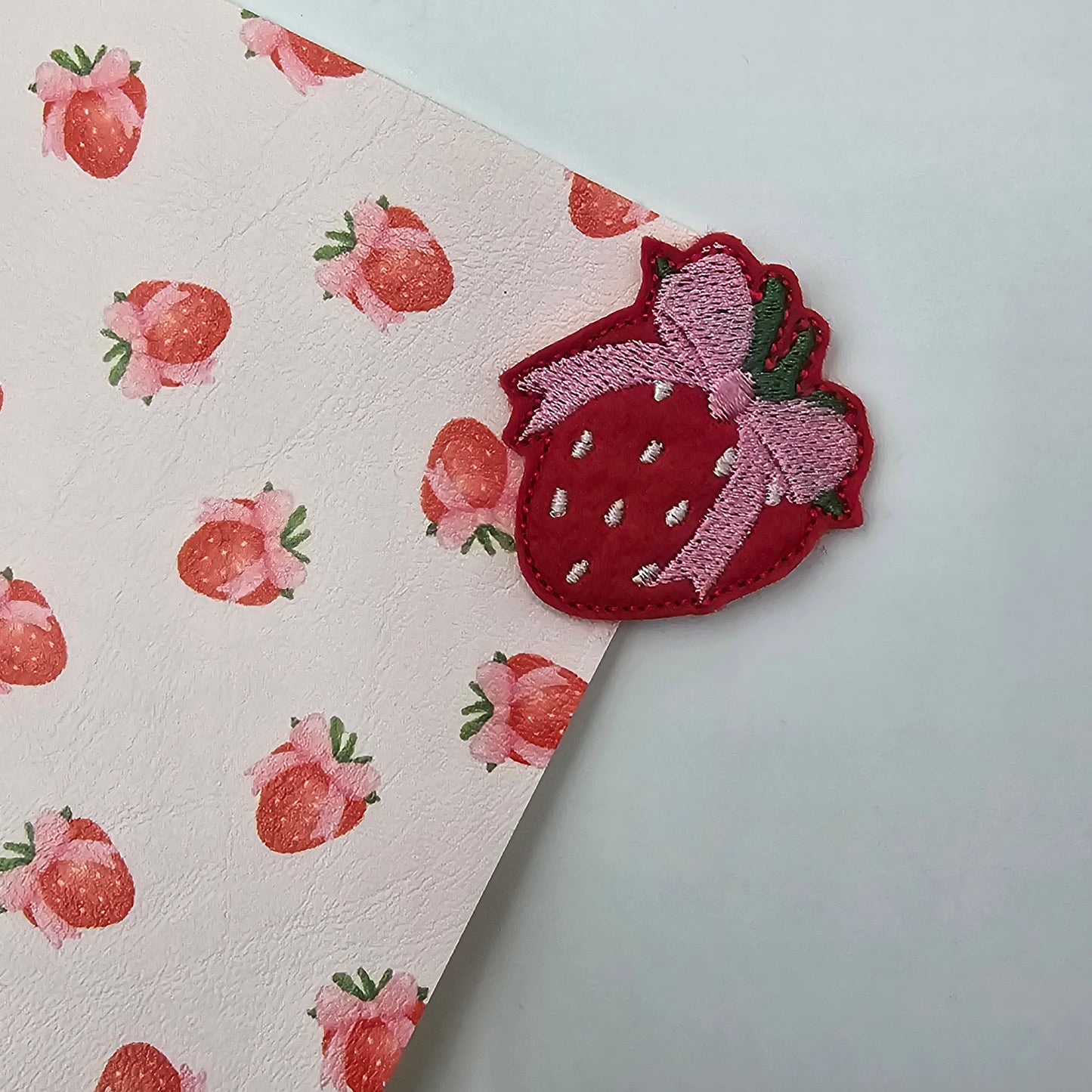 Strawberry bows on pale pink Artisan Leatherette