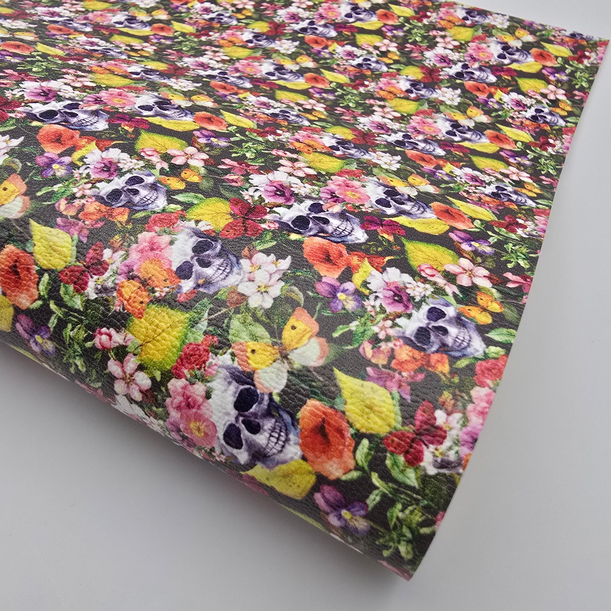 Floral and skull patterned fabric on a gray background