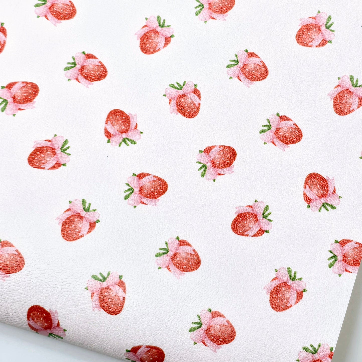 Strawberry bows on pale pink Artisan Leatherette